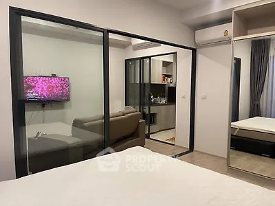 Modern apartment interior with glass partition and cozy living area