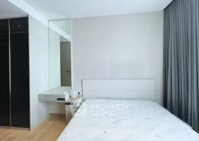 Modern minimalist bedroom with sleek design and ample natural light