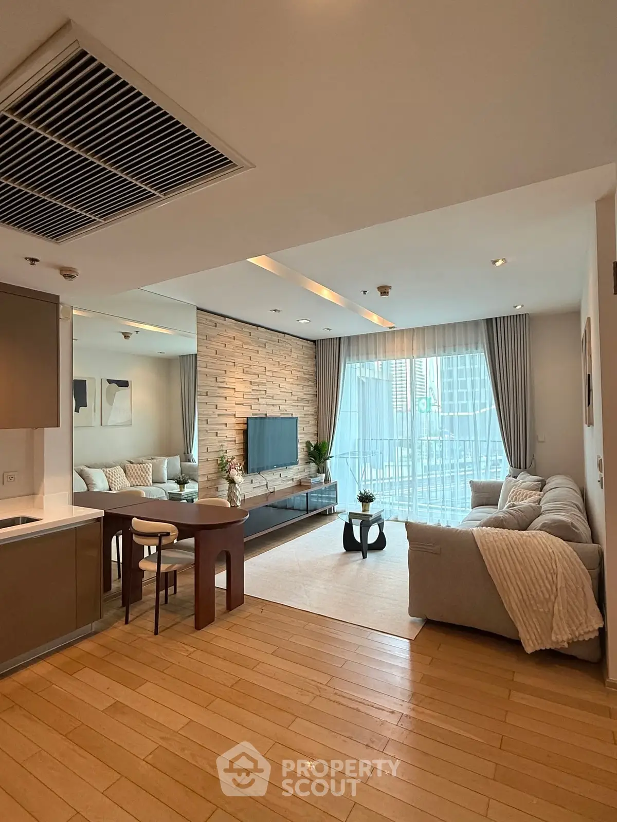 Spacious modern living room with elegant decor and large windows for natural light.