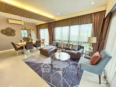 Luxurious modern living room with elegant decor and ample natural light.