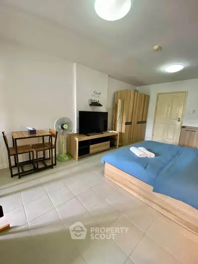 Cozy studio apartment with modern furnishings and tiled flooring