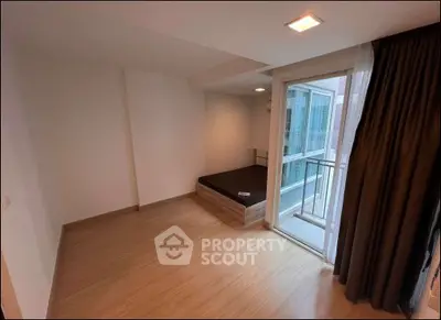 Spacious bedroom with balcony access in modern apartment