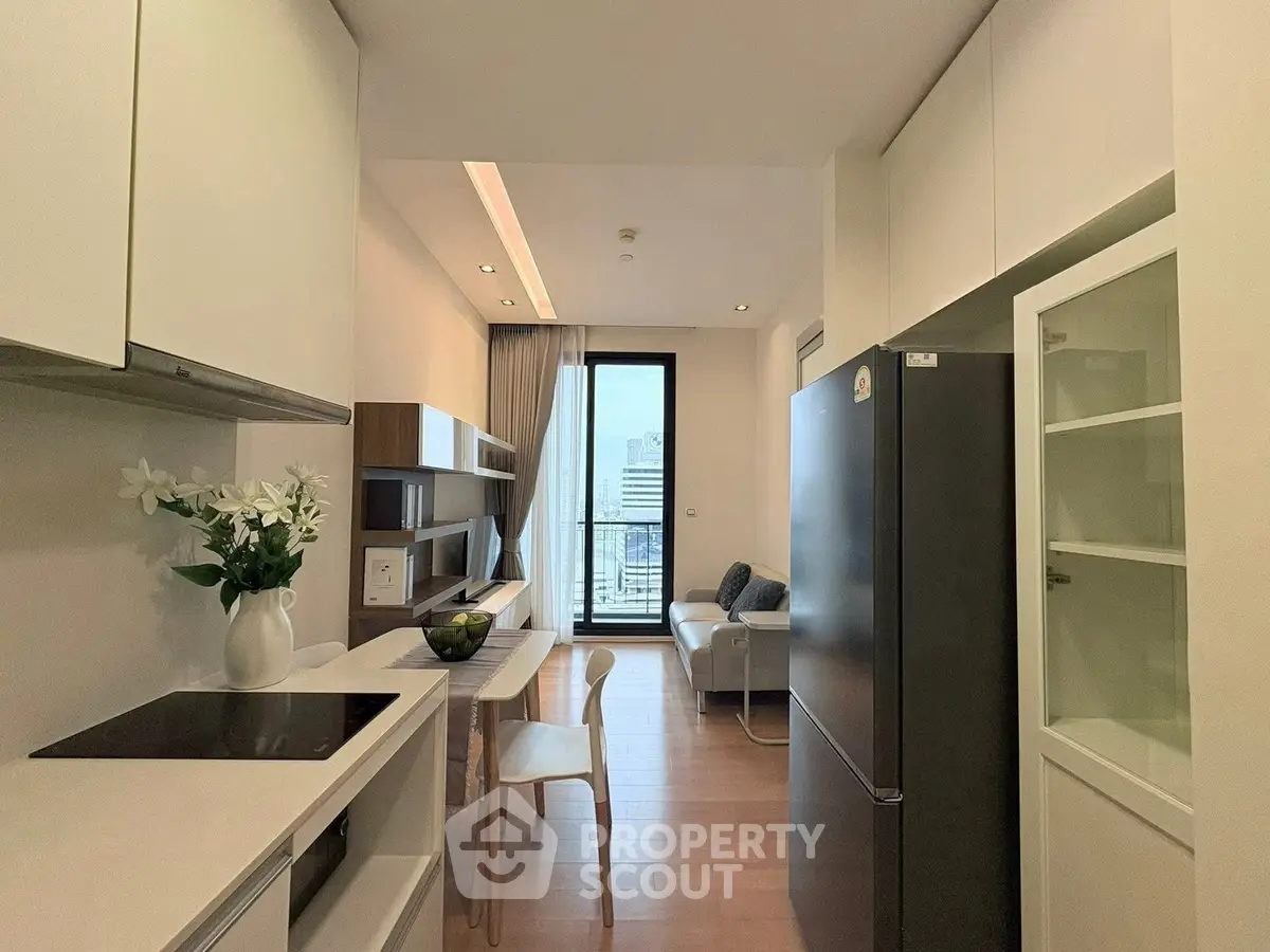 Modern kitchen and living area with sleek design and city view.