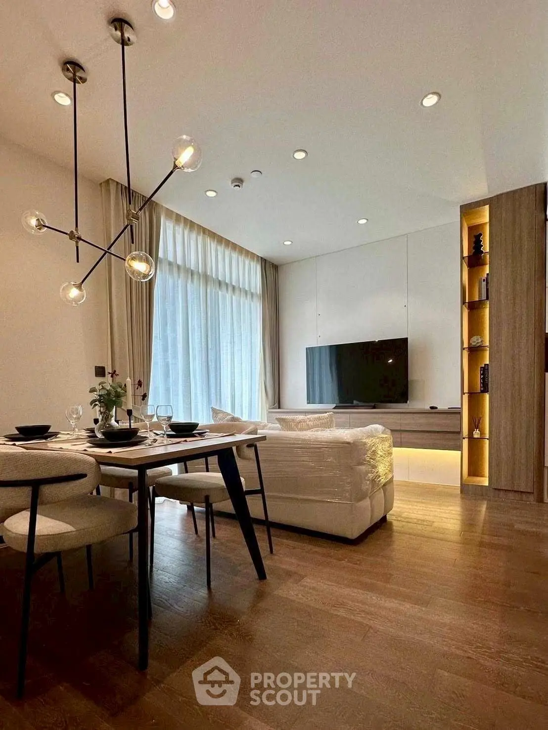 Elegant modern living room with stylish lighting and cozy dining area