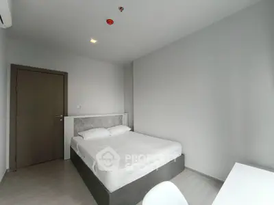 Modern minimalist bedroom with sleek design and neutral tones, perfect for a serene living space.