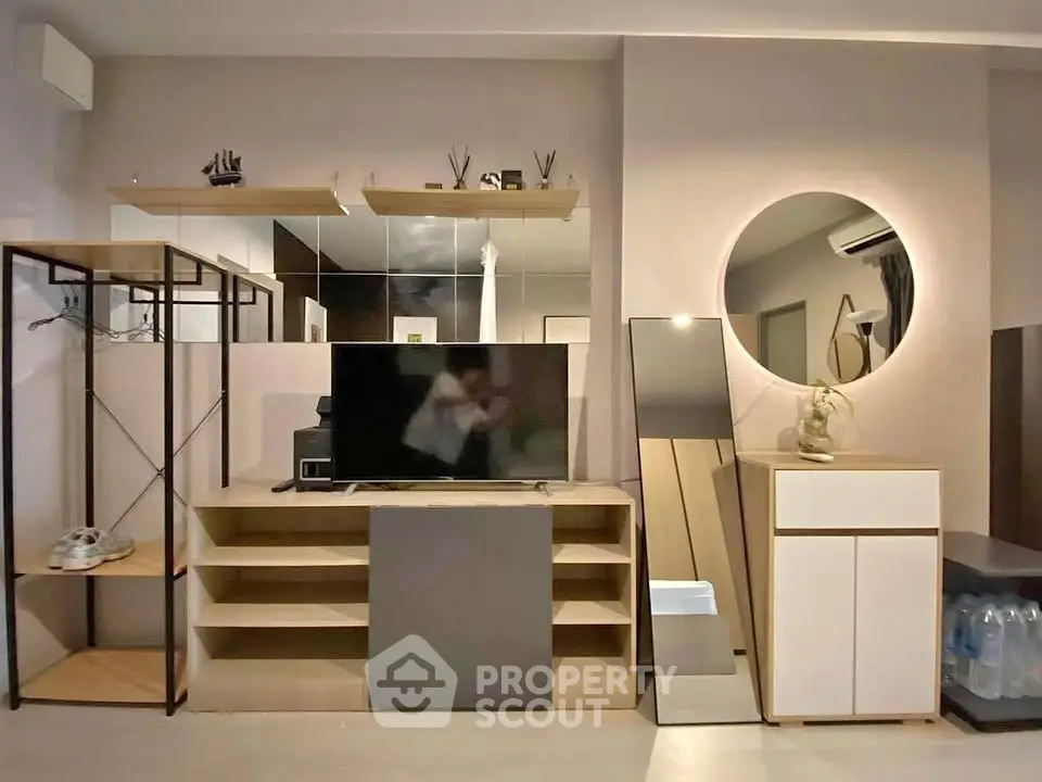 Modern living room with stylish shelving and large mirror, perfect for contemporary urban living.