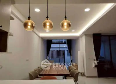 Modern dining area with stylish pendant lights and elegant decor