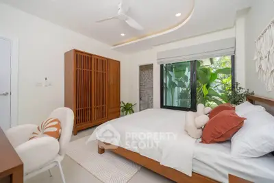 Elegant bedroom with modern decor, large window, and cozy furnishings in a serene setting.