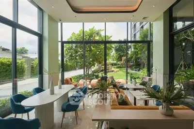 Luxurious modern living room with large windows overlooking a lush garden, featuring elegant furniture and decor.