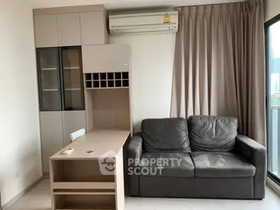 Modern living room with sleek furniture and large window for natural light.