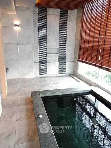 Luxurious indoor pool with modern design and elegant lighting