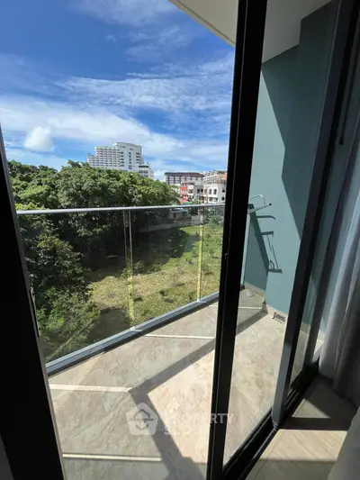 Stunning balcony view with lush greenery and cityscape, perfect for relaxation and enjoying the outdoors.