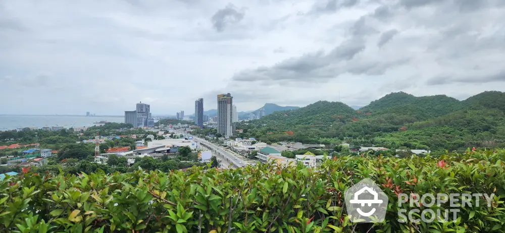 Stunning panoramic city and mountain view from a lush green rooftop garden