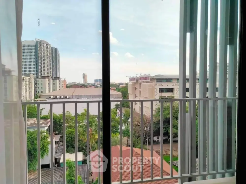 Stunning cityscape view from modern apartment balcony with lush greenery