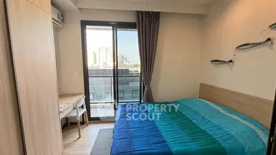 Cozy bedroom with balcony view in modern apartment