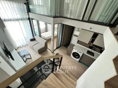 Modern duplex apartment with open living area and washing machine