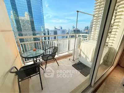 Stunning city view from a high-rise balcony with modern furniture