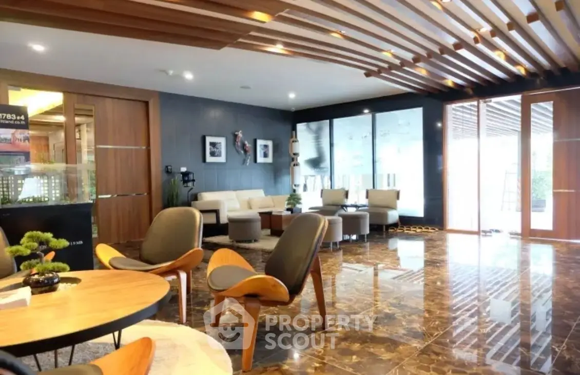 Luxurious modern living room with stylish furniture and elegant wooden ceiling design.