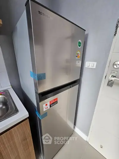 Modern kitchen with sleek stainless steel refrigerator and stylish cabinetry