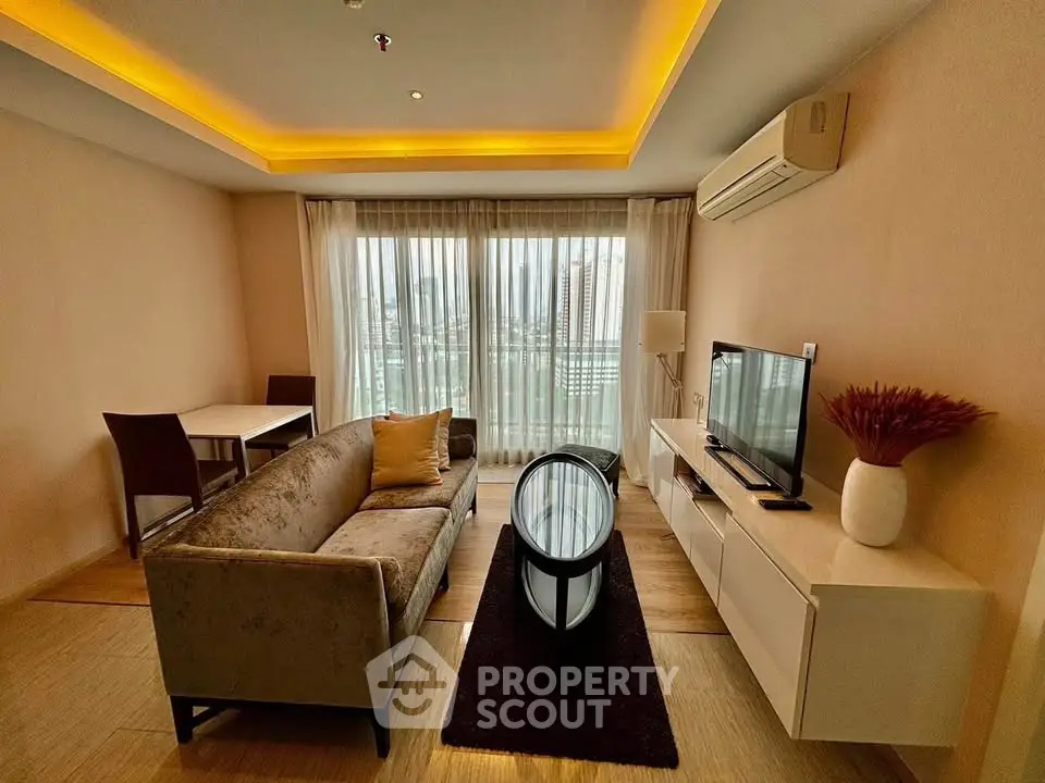 Modern living room with elegant decor, featuring a plush sofa, sleek TV unit, and ambient lighting.