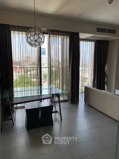 Spacious living room with floor-to-ceiling windows and modern decor