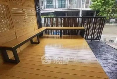Modern outdoor patio with sleek wooden flooring and stylish bench seating.