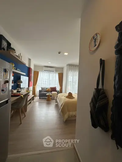 Modern studio apartment with open layout, cozy living area, and stylish decor.