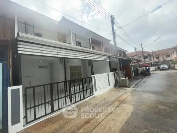 Modern townhouse exterior with sleek design in a quiet neighborhood.