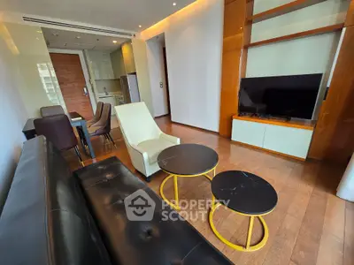 Modern living room with sleek furniture and open kitchen layout, perfect for urban living.