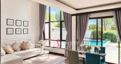 Luxurious living room with pool view, elegant decor, and large windows for natural light.