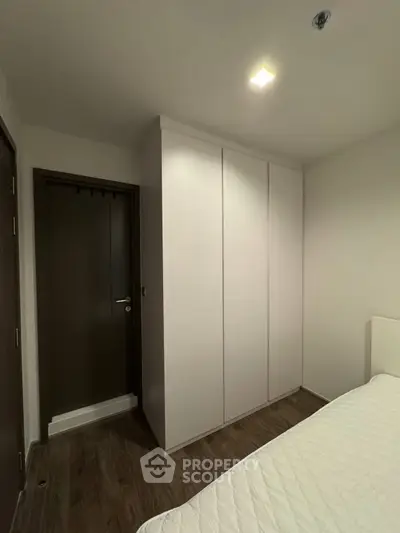 Modern bedroom with sleek wardrobe and cozy ambiance