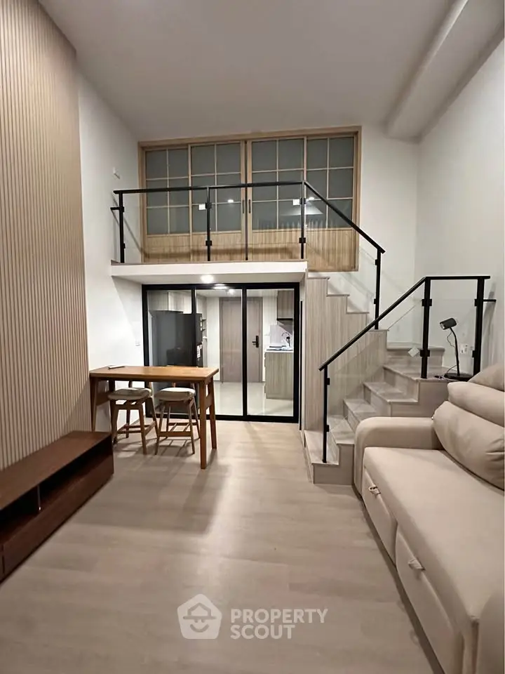Modern loft-style living room with mezzanine and sleek interior design