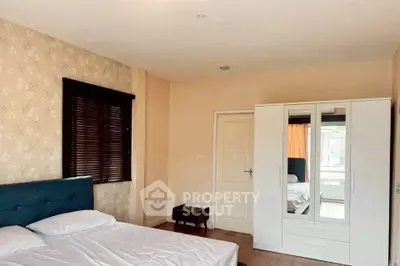 Spacious bedroom with modern decor and ample natural light