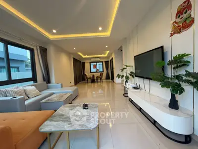 Spacious modern living room with elegant decor and ample natural light, perfect for relaxation and entertainment.