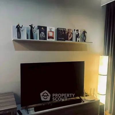 Stylish living room with modern TV setup and decorative shelf display.