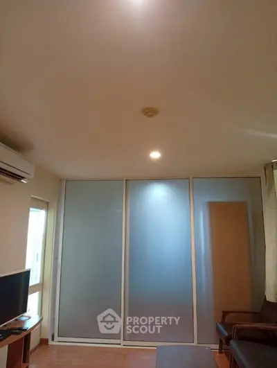 Modern living room with frosted glass sliding doors and sleek furniture