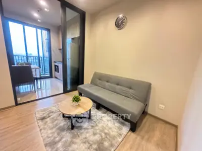 Modern living room with cozy sofa and open kitchen layout in stylish apartment
