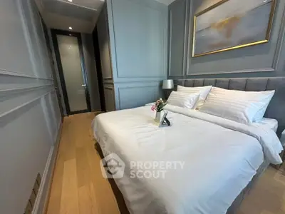 Luxurious bedroom with elegant decor and cozy ambiance, featuring a plush bed and stylish wall art.