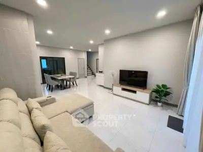 Spacious modern living room with elegant dining area and neutral tones