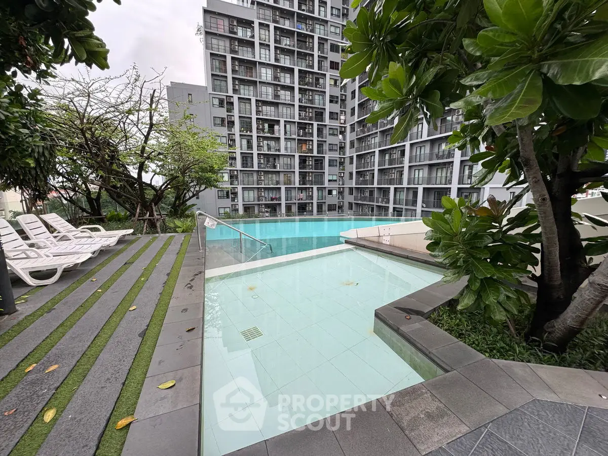 Modern condominium with pool and lush greenery, ideal for urban living.