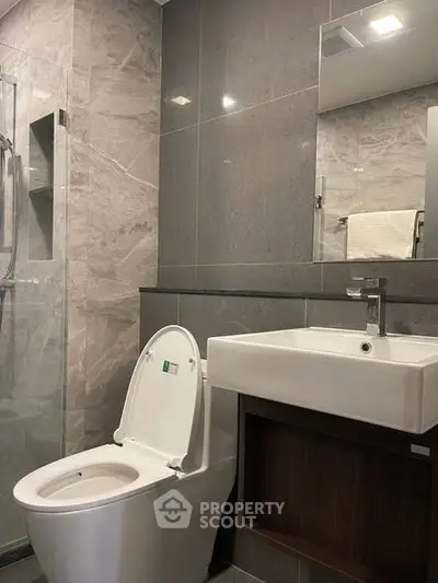 Modern bathroom with sleek fixtures and elegant gray tiles