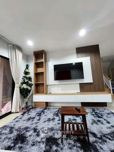 Modern living room with stylish TV unit and cozy rug, perfect for relaxation and entertainment.