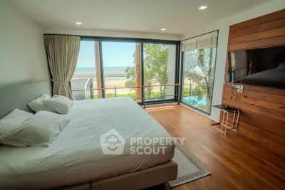 Luxurious beachfront bedroom with stunning ocean view and modern decor