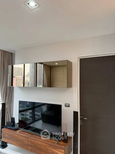 Modern living room with sleek TV setup and stylish storage cabinets