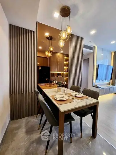 Modern dining area with elegant lighting and stylish decor in a contemporary apartment.