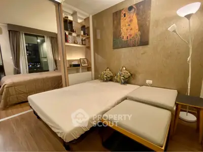 Cozy bedroom with modern decor and city view, featuring a comfortable bed and stylish lighting.