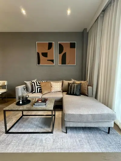 Modern living room with stylish sectional sofa and abstract art