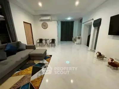 Spacious modern living room with stylish decor and ample seating, perfect for relaxation and entertainment.
