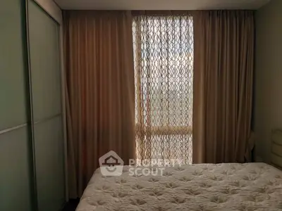 Cozy bedroom with elegant curtains and soft bedding