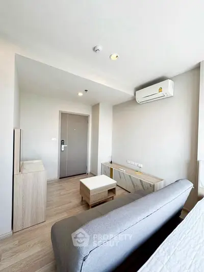 Modern living room with sleek furniture and air conditioning in a bright apartment.